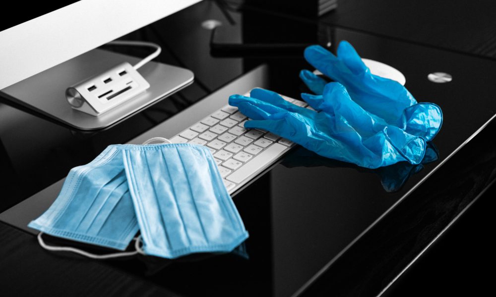 Coronavirus. A medical mask lies near a laptop in the workplace.